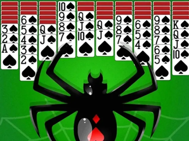 Spider Solitaire columns of spade cards above a large black spider on a green table